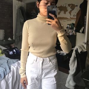 Cream / pastel yellow Uniqlo wool turtleneck sweater